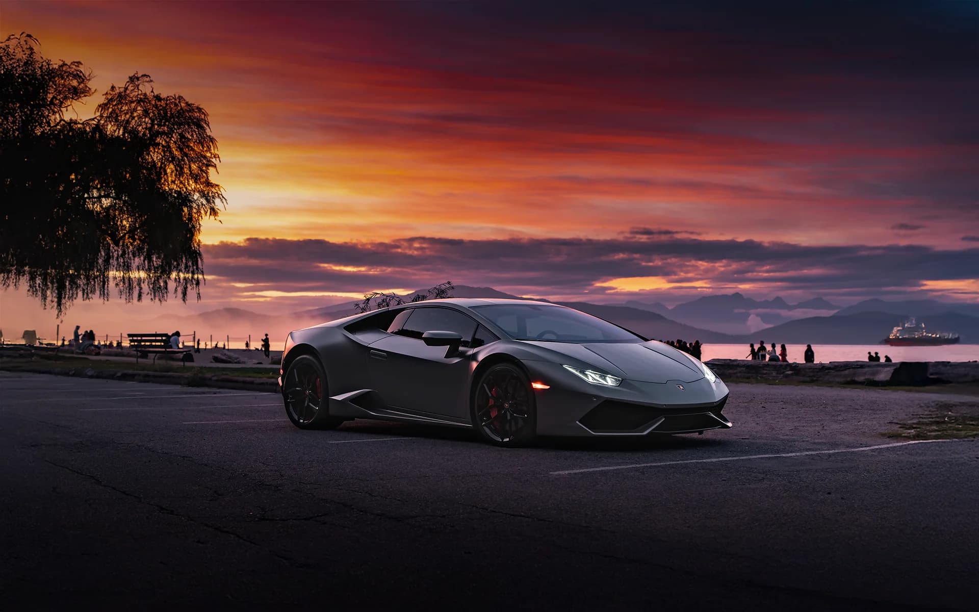 Lamborghini Huracan at sunset with ocean and mountains behind