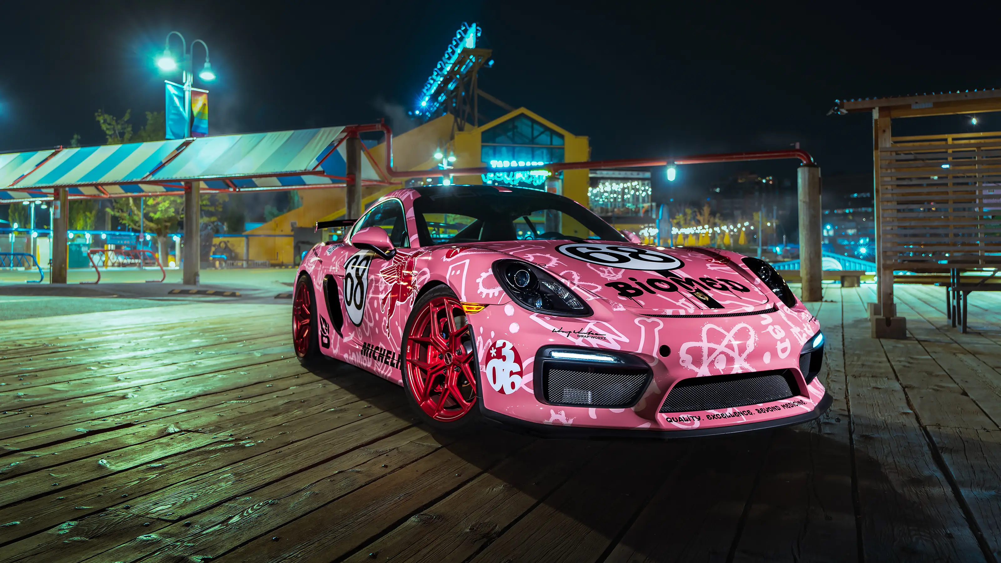 Pink Porsche Cayman GT4 front view at night in Vancouver