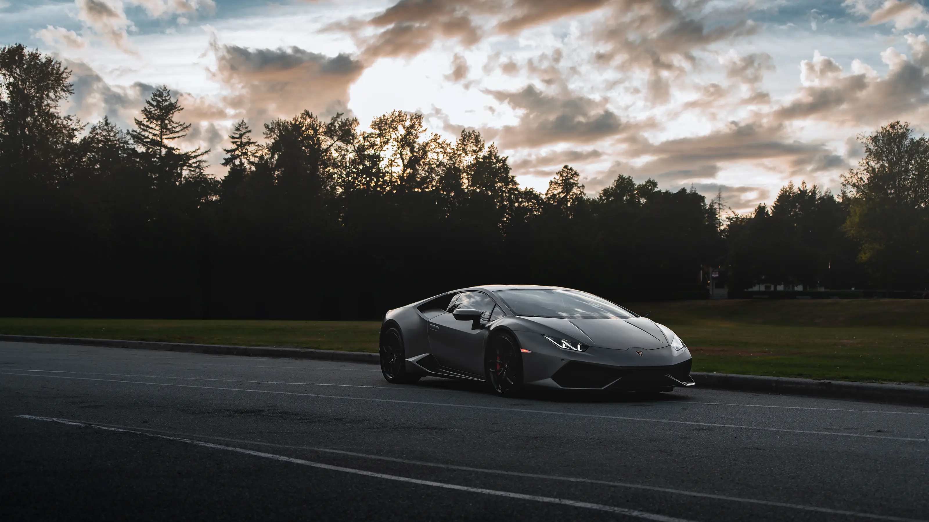 Matte gray Lamborghini Huracan photographed with open sky behind