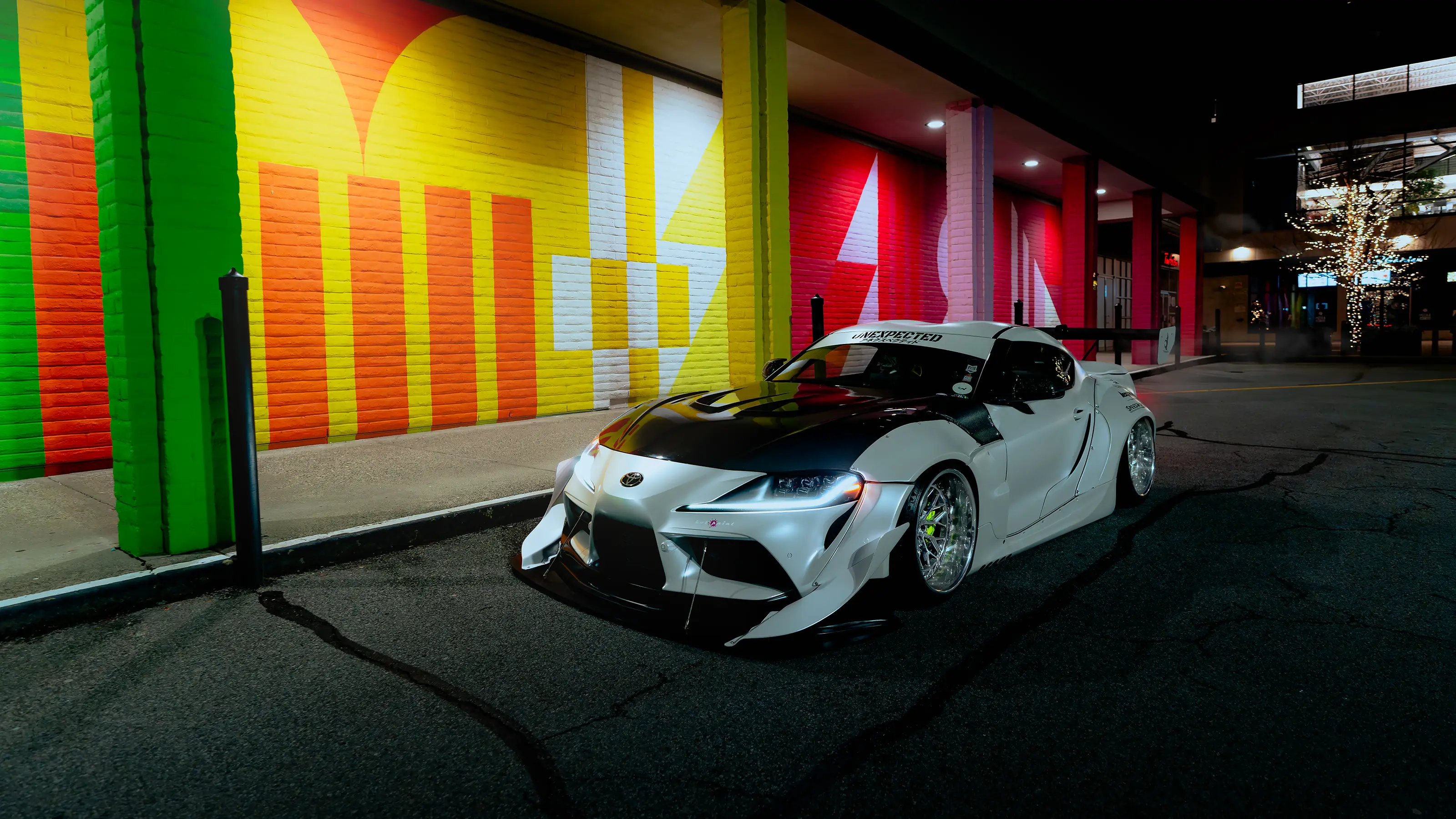 White widebody Toyota Supra photographed in an industrial area