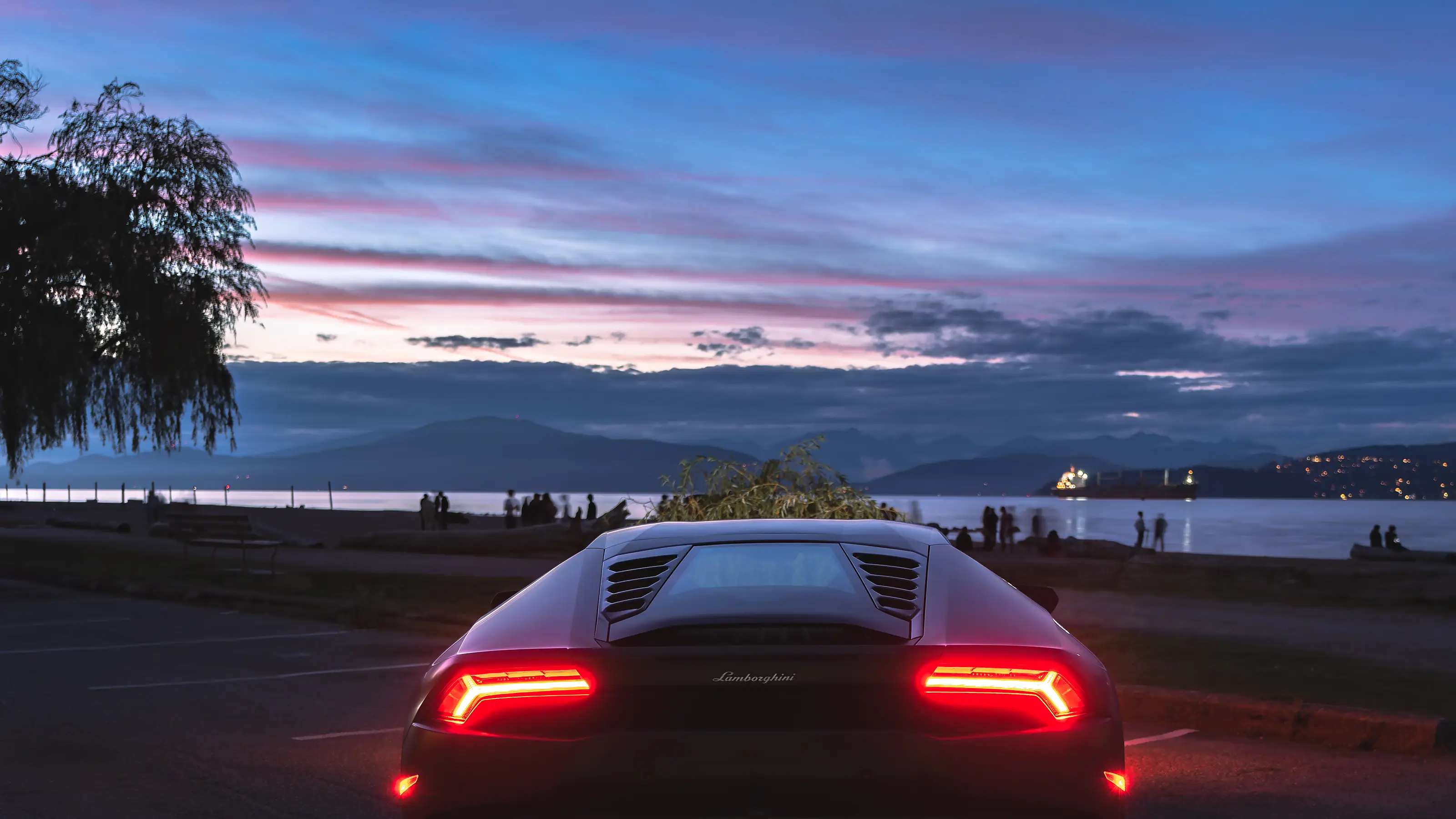Rear view of the Lamborghini Huracán against a Vancouver sunset sky